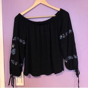 Black top with flower embroidery down the sleeves